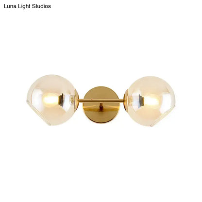 Modernist gold wall lamp with glass shade for living room