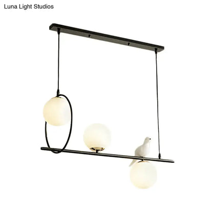 Modernist milk glass pendant with bird accent black dining room light