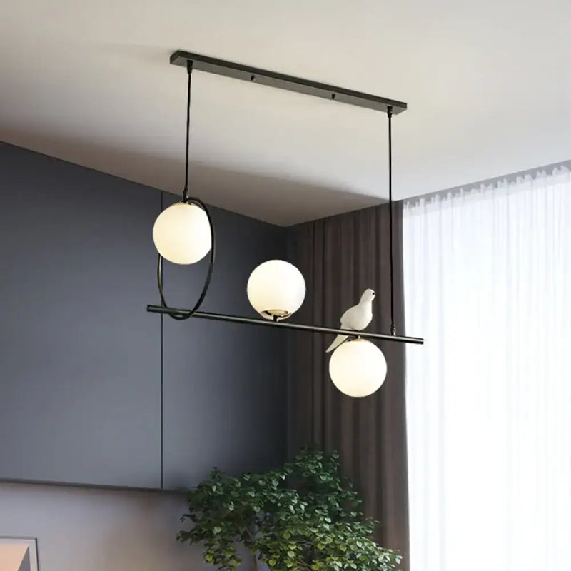 Modernist milk glass pendant with bird accent black dining room light
