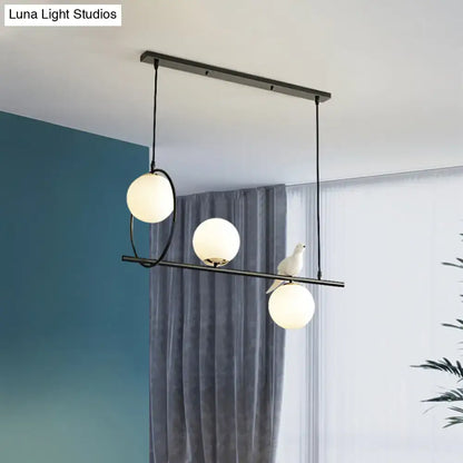 Modernist milk glass pendant with bird accent black dining room light