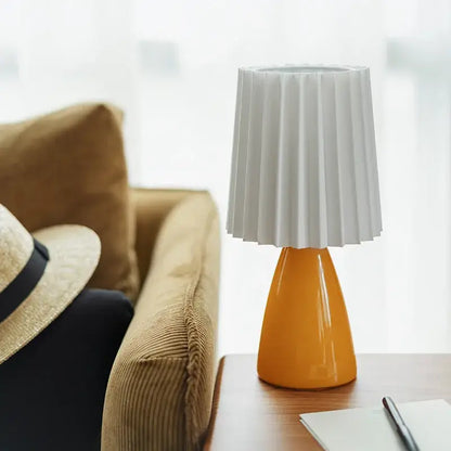 Orange ceramic milkshake bedside lamp with pleated shade for bedroom