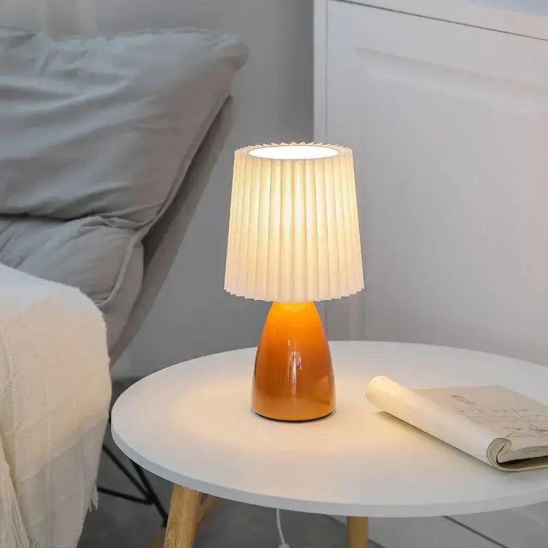 Orange ceramic milkshake bedside lamp with pleated shade for bedroom