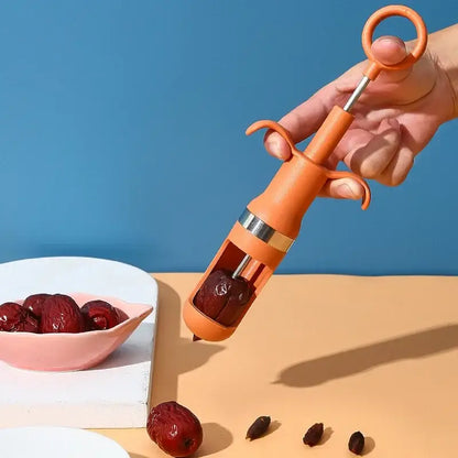 Orange metal cherry pitter fruit core remover kitchen tool
