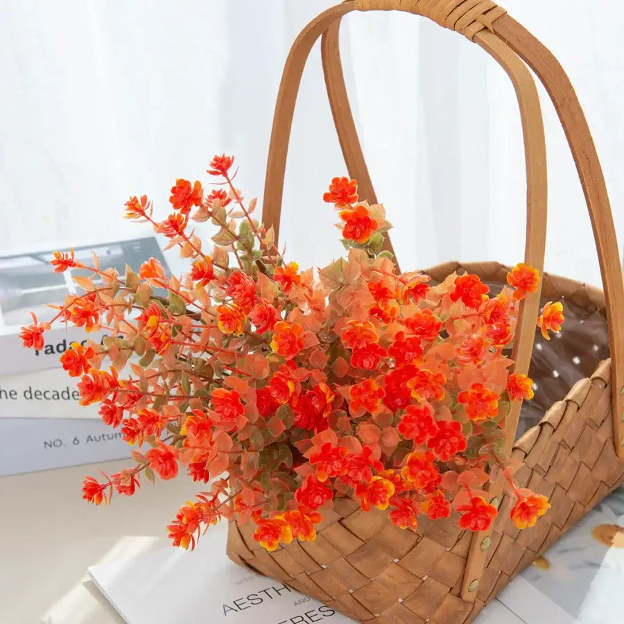 Orange & red artificial eucalyptus leaves in white pitcher – garden decor