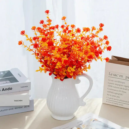 Orange & red artificial eucalyptus leaves in white pitcher – garden decor