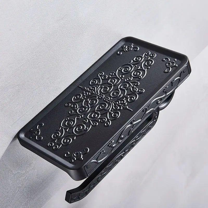 Ornate black metal toilet paper holder with phone shelf bathroom storage