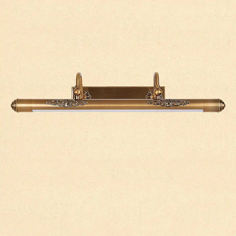 Ornate brass bathroom mirror lamp with decorative scrollwork