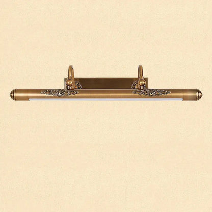 Ornate brass bathroom mirror lamp with decorative scrollwork