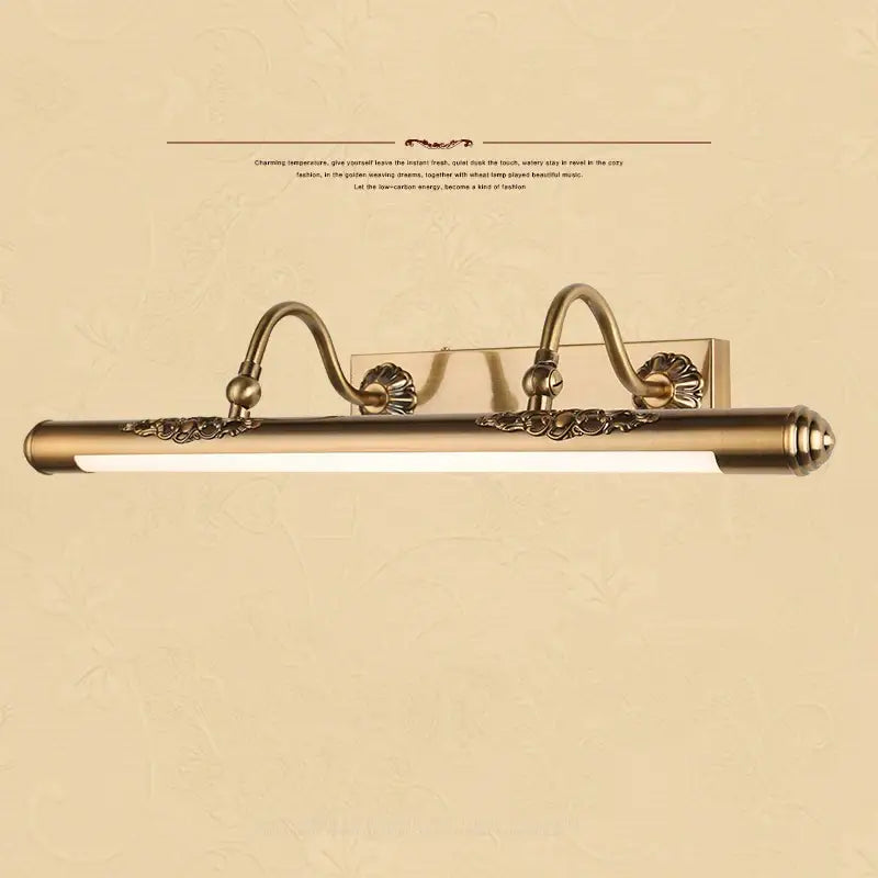 Ornate brass bathroom mirror lamp with decorative scrollwork