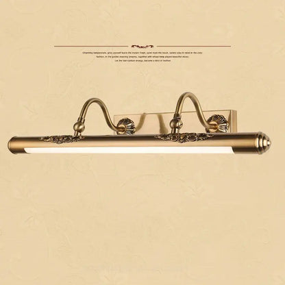 Ornate brass bathroom mirror lamp with decorative scrollwork