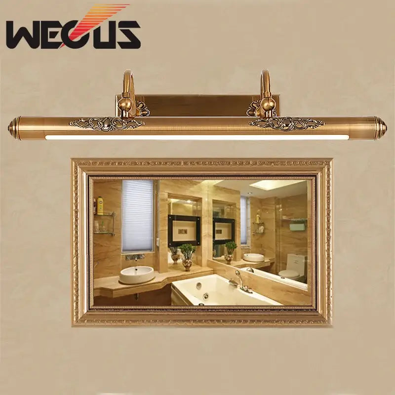 Ornate brass bathroom mirror lamp with decorative scrollwork