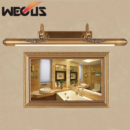 Ornate brass bathroom mirror lamp with decorative scrollwork
