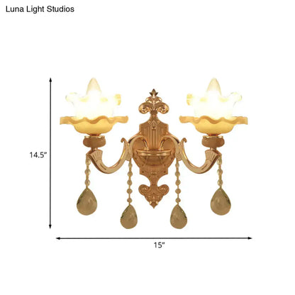 Ornate gold crystal wall sconce with frosted glass shade living room