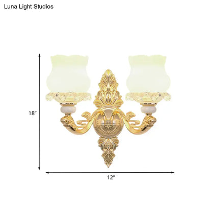 Ornate gold wall light with glass bloom shades – living room fixture
