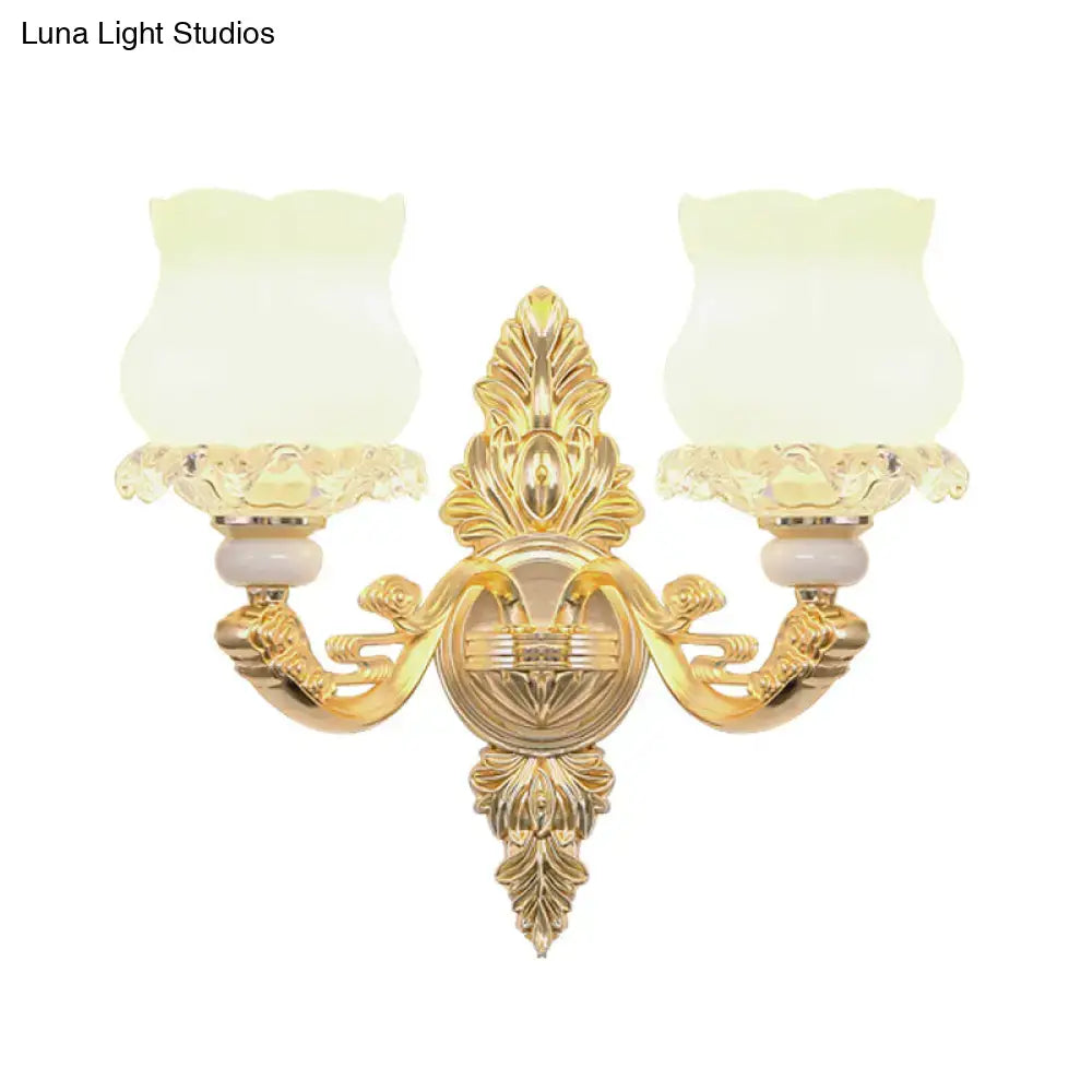 Ornate gold wall light with glass bloom shades – living room fixture