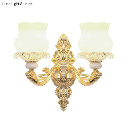 Ornate gold wall light with glass bloom shades – living room fixture