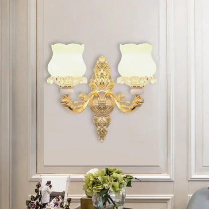 Ornate gold wall light with glass bloom shades – living room fixture