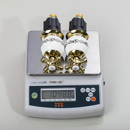 Ornate gold & white porcelain bathroom faucet set