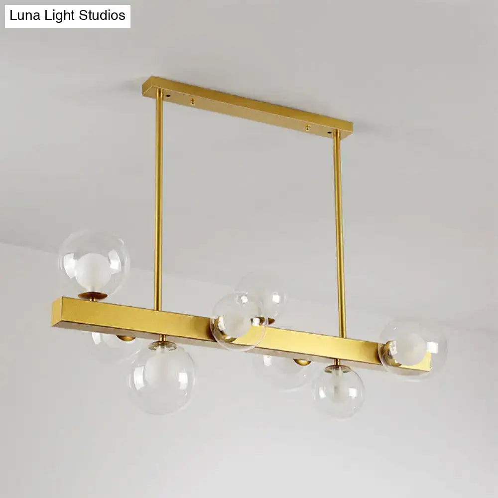 Post modern gold chandelier with glass globes for dining room