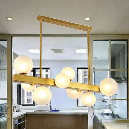 Post modern gold chandelier with glass globes for dining room