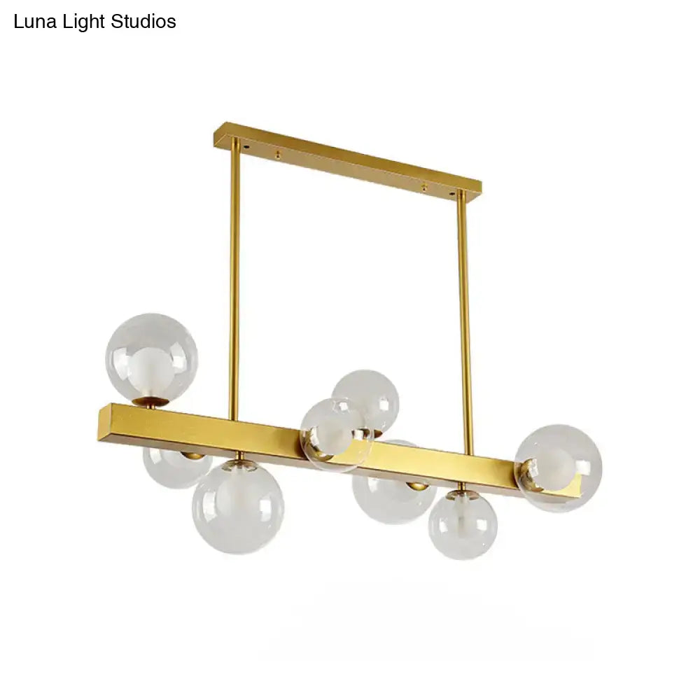 Post modern gold chandelier with glass globes for dining room