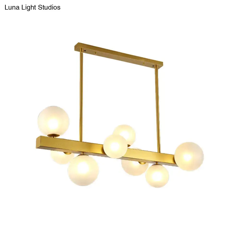 Post modern gold chandelier with glass globes for dining room