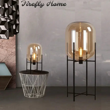 Postmodern amber glass ball floor lamp – living room black metal frame