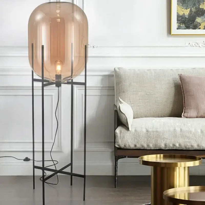 Postmodern amber glass ball floor lamp – living room black metal frame