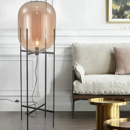 Postmodern amber glass ball floor lamp – living room black metal frame