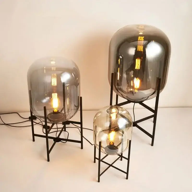 Postmodern amber glass ball floor lamp – living room black metal frame