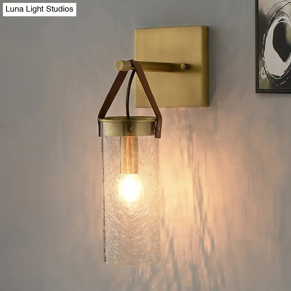 Postmodern brass wall sconce with clear crack glass and leather strap dining room light