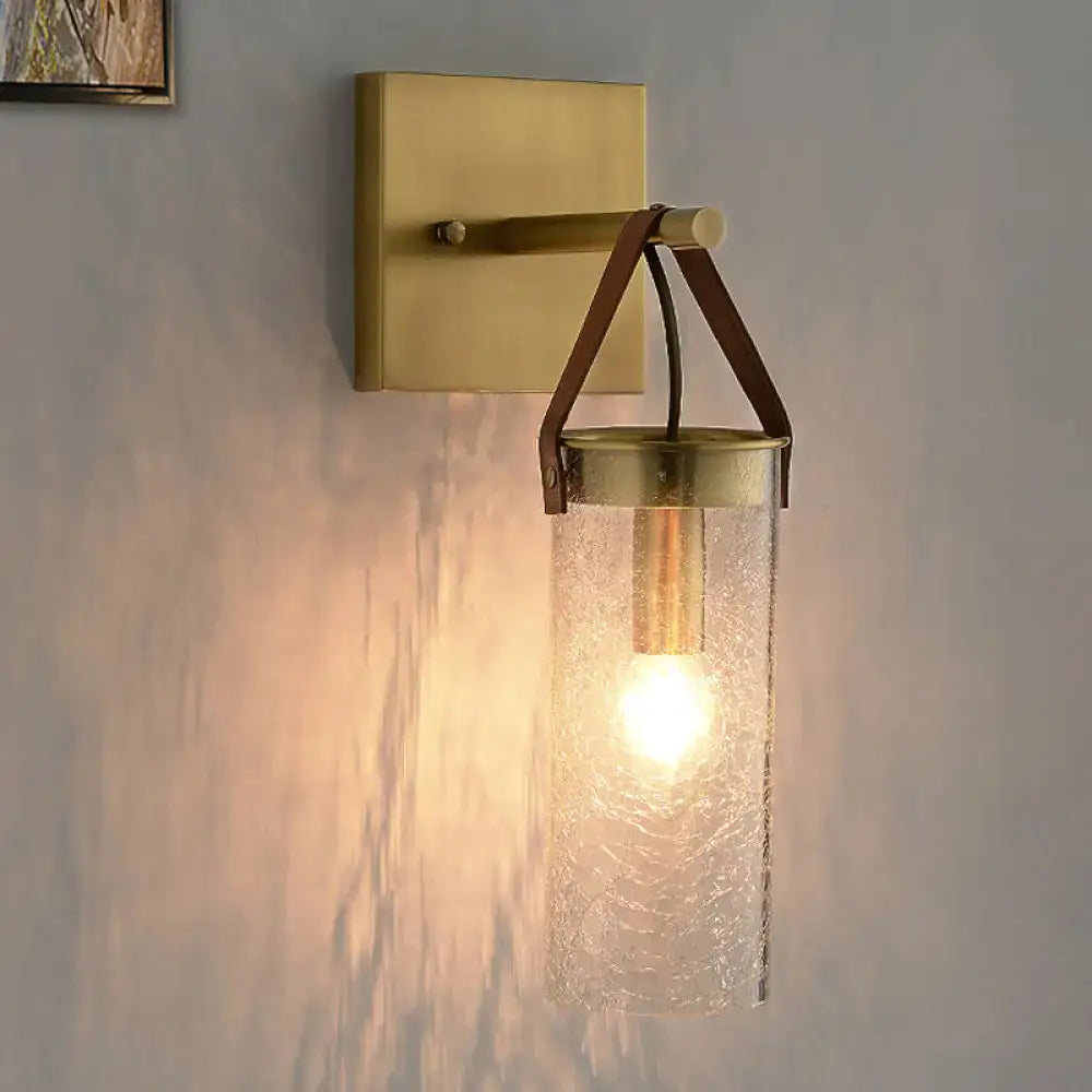 Postmodern brass wall sconce with clear crack glass and leather strap dining room light