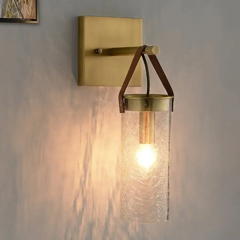 Postmodern brass wall sconce with clear crack glass and leather strap dining room light