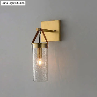 Postmodern brass wall sconce with clear crack glass and leather strap dining room light