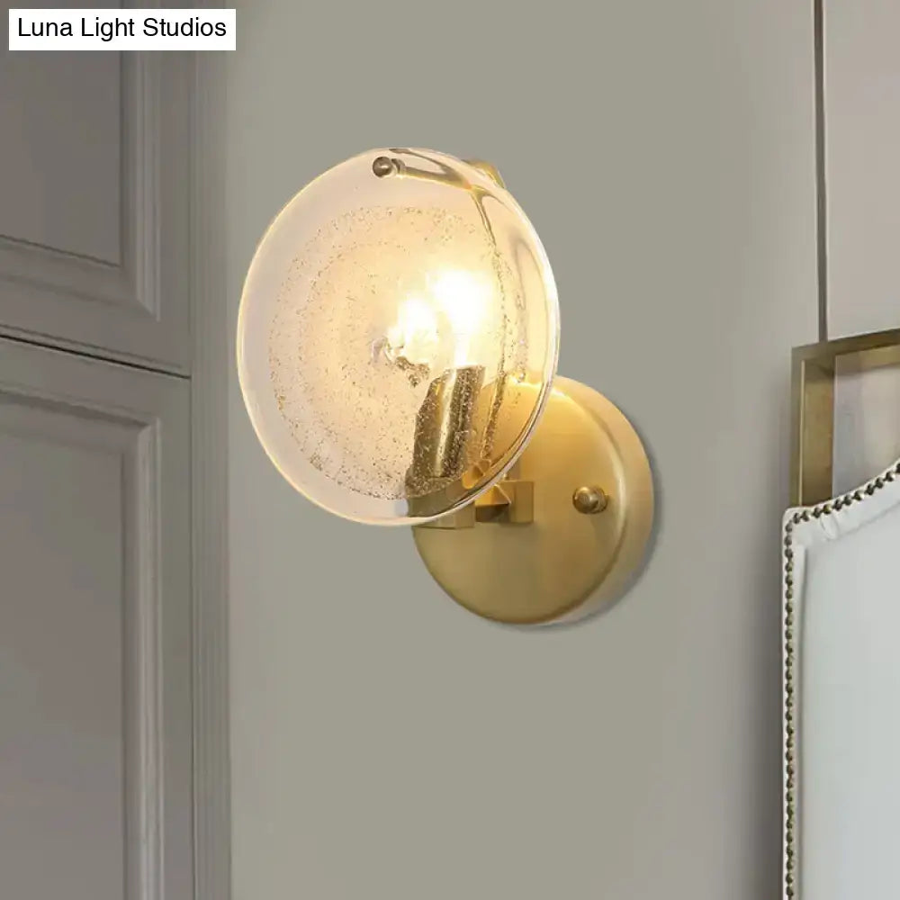 Postmodern gold metal wall sconce with clear glass shade bedroom light