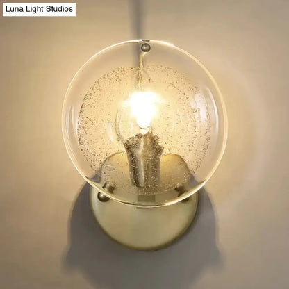 Postmodern gold metal wall sconce with clear glass shade bedroom light