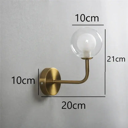 Retro brass curved wall lamp with clear glass ball for bedroom