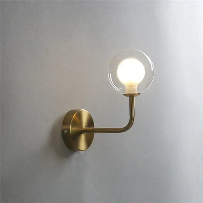 Retro brass curved wall lamp with clear glass ball for bedroom