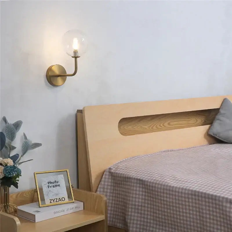 Retro brass curved wall lamp with clear glass ball for bedroom