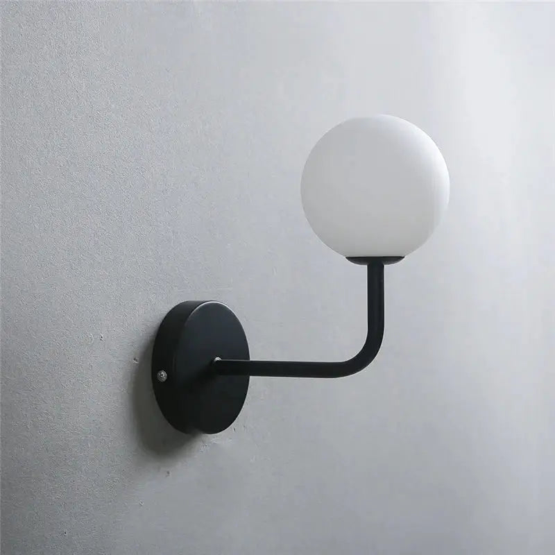 Retro brass curved wall lamp with clear glass ball for bedroom