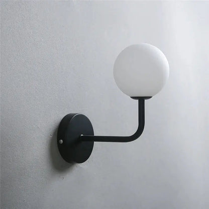Retro brass curved wall lamp with clear glass ball for bedroom