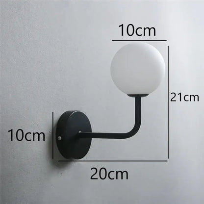 Retro brass curved wall lamp with clear glass ball for bedroom