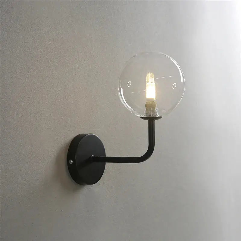 Retro brass curved wall lamp with clear glass ball for bedroom