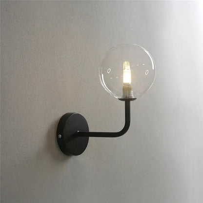 Retro brass curved wall lamp with clear glass ball for bedroom