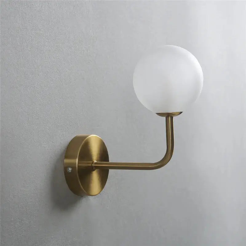 Retro brass curved wall lamp with clear glass ball for bedroom