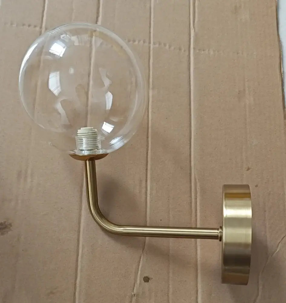 Retro brass curved wall lamp with clear glass ball for bedroom