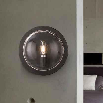 Retro dark gray metal wall sconce with clear glass shade living room