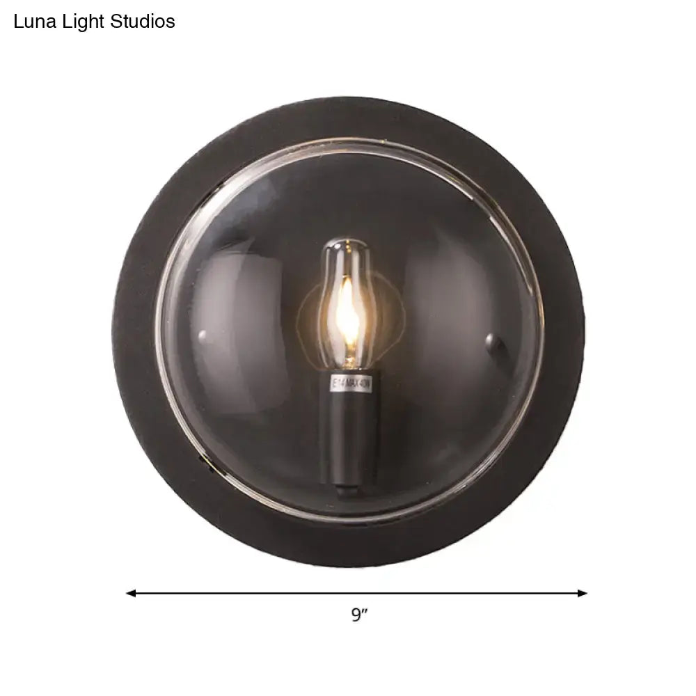 Retro dark gray metal wall sconce with clear glass shade living room