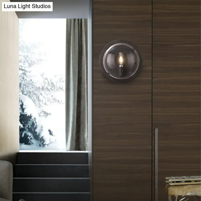 Retro dark gray metal wall sconce with clear glass shade living room