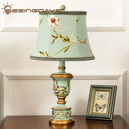 Retro mint green resin table lamp with butterfly detail bedroom light